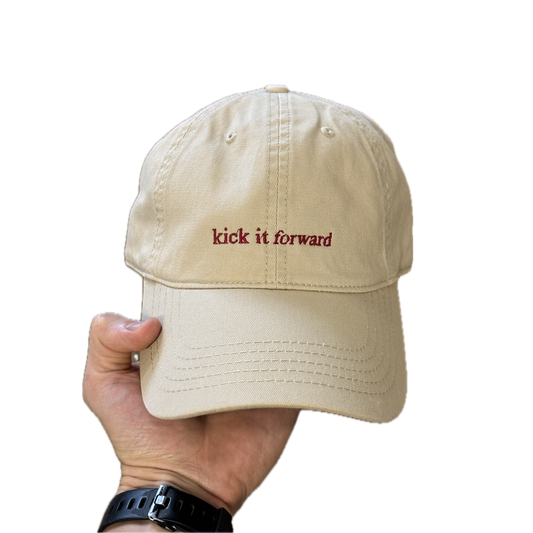 Kick it Forward red text on cream cap